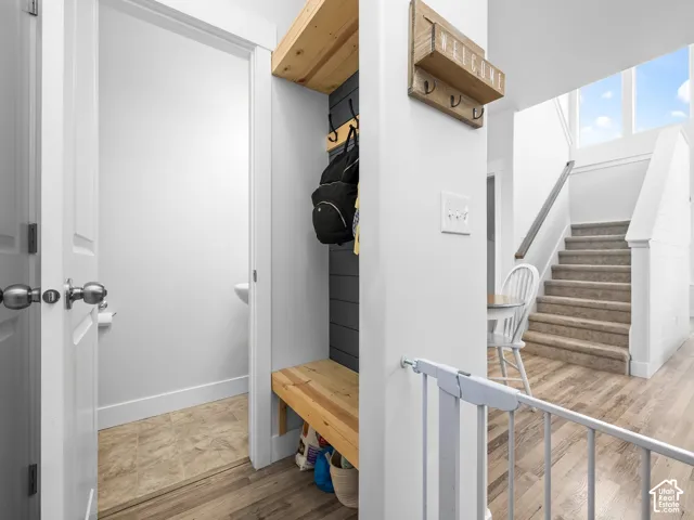 Entryway featuring wood-finish flooring and a built-in bench with open shelving