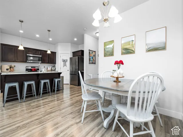 Wood-finish flooring throughout, complemented by a contemporary chandelier