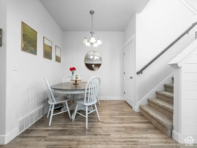 Wood-finish flooring, white walls, and a contemporary ceiling light fixture