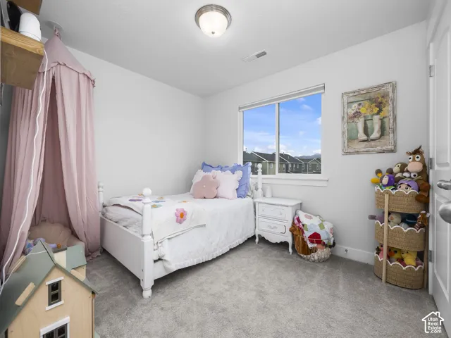 Recessed window with white trim, light gray wall paint, and gray carpet flooring