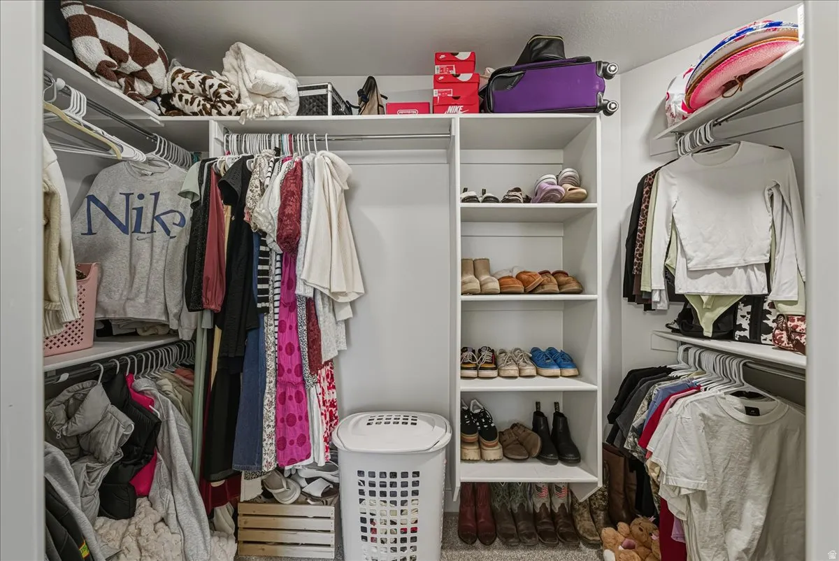 Built-in closet shelving, hanging rods, and ample storage space
