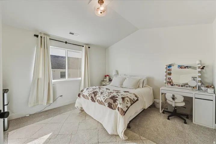 Vaulted ceiling, light-toned carpeting, window with blinds, recessed lighting, and a contemporary ceiling light fixture