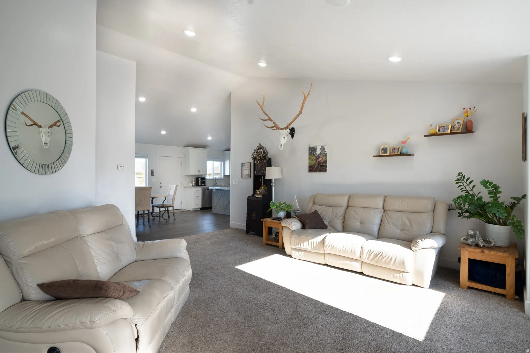 Recessed lighting, wood-finish flooring, white walls, and an open layout
