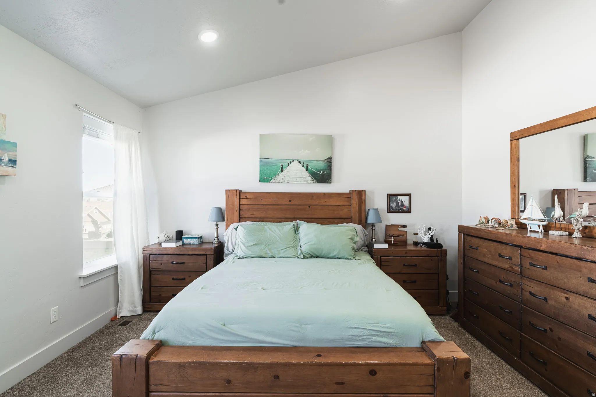 Vaulted ceilings, recessed lighting, and expansive window