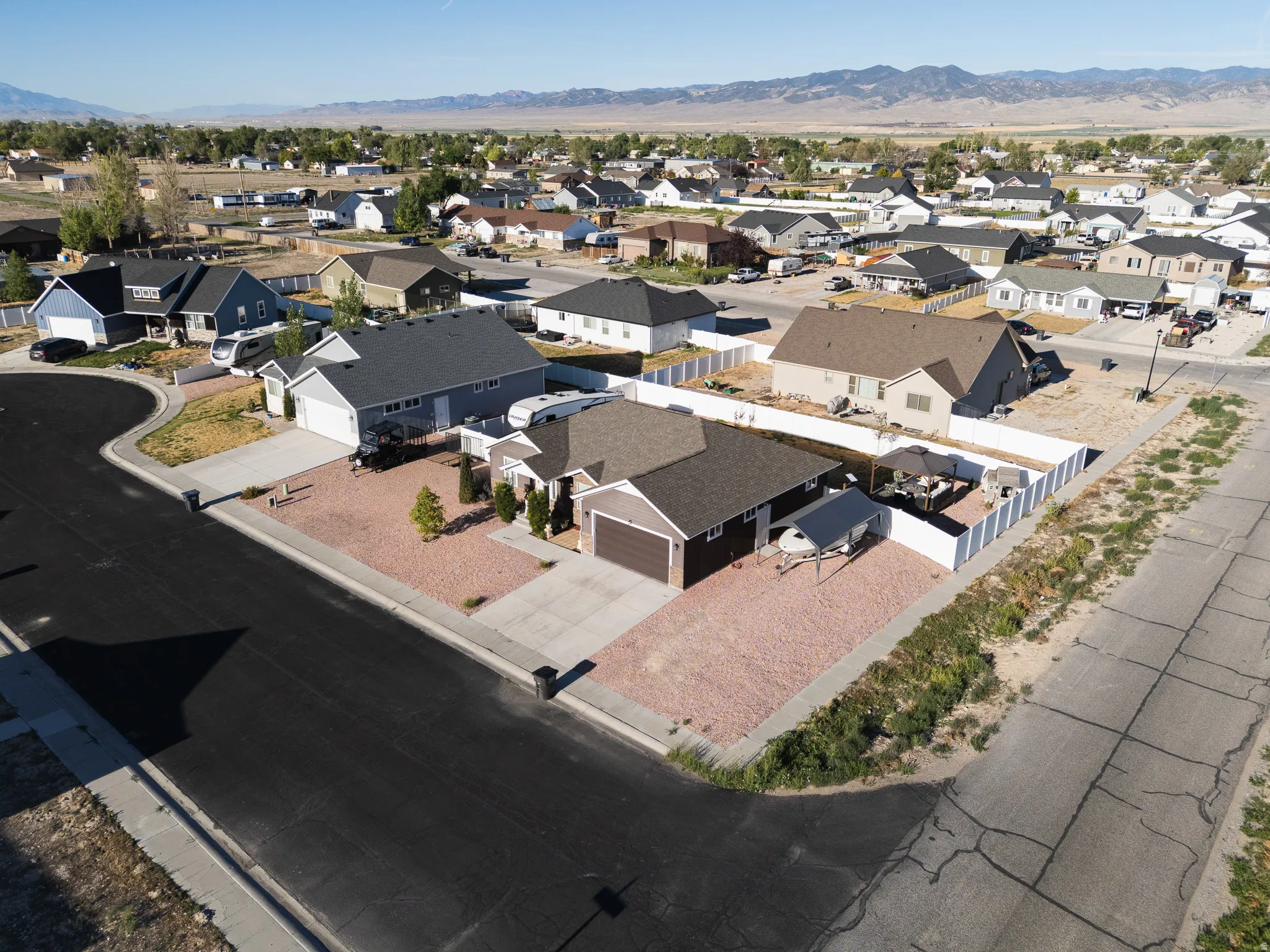 Newly constructed residence featuring a neutral exterior, a single-car garage, and a white privacy fence