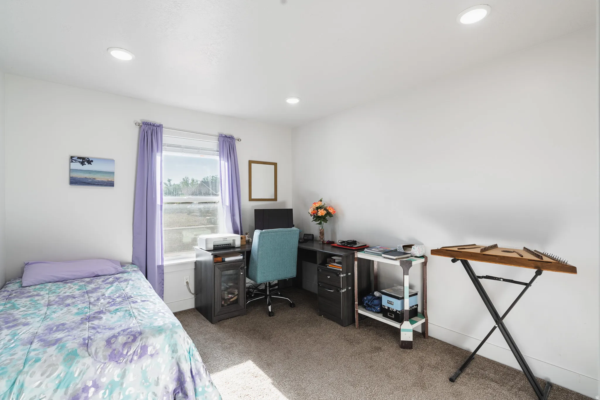 Recessed lighting, white walls, carpeted flooring, and a window with trim