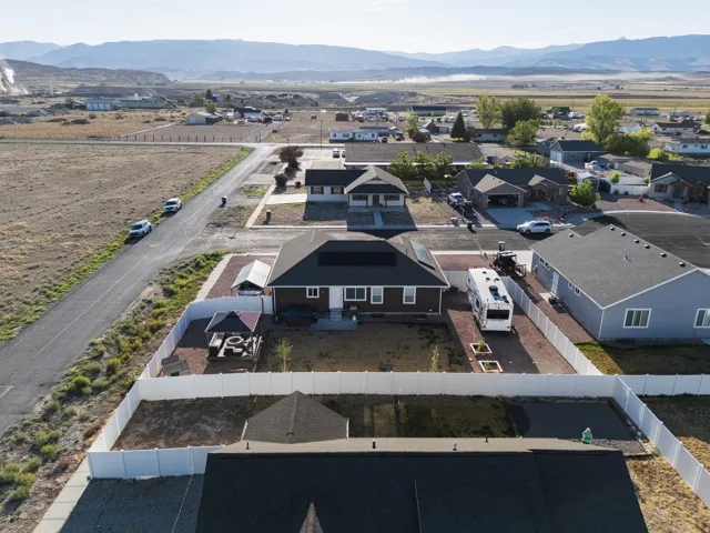 Single-story residence with a dark roof and solar panels