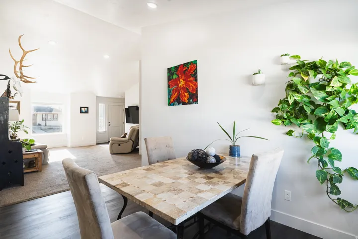 Dining area featuring a tiled surface dining table, recessed lighting, and dark wood-finish flooring