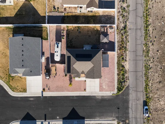 Property featuring a dark shingle roof, solar panels, and a covered patio area