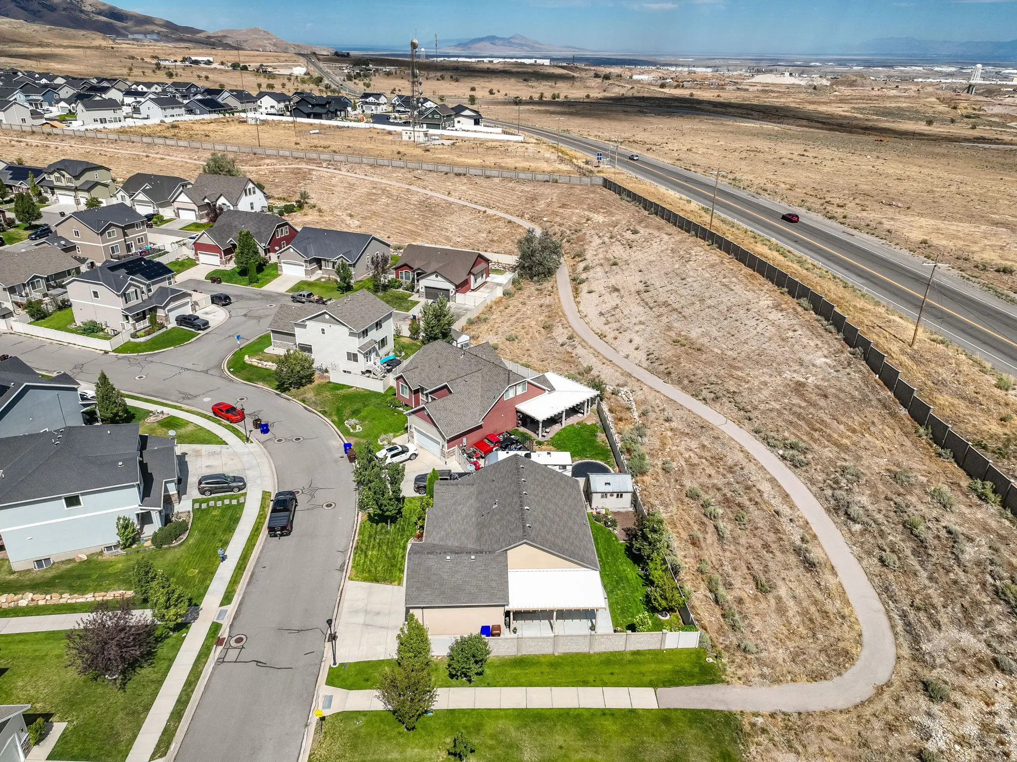 Community setting with a paved path, paved roadways, and residential properties featuring varied architectural styles