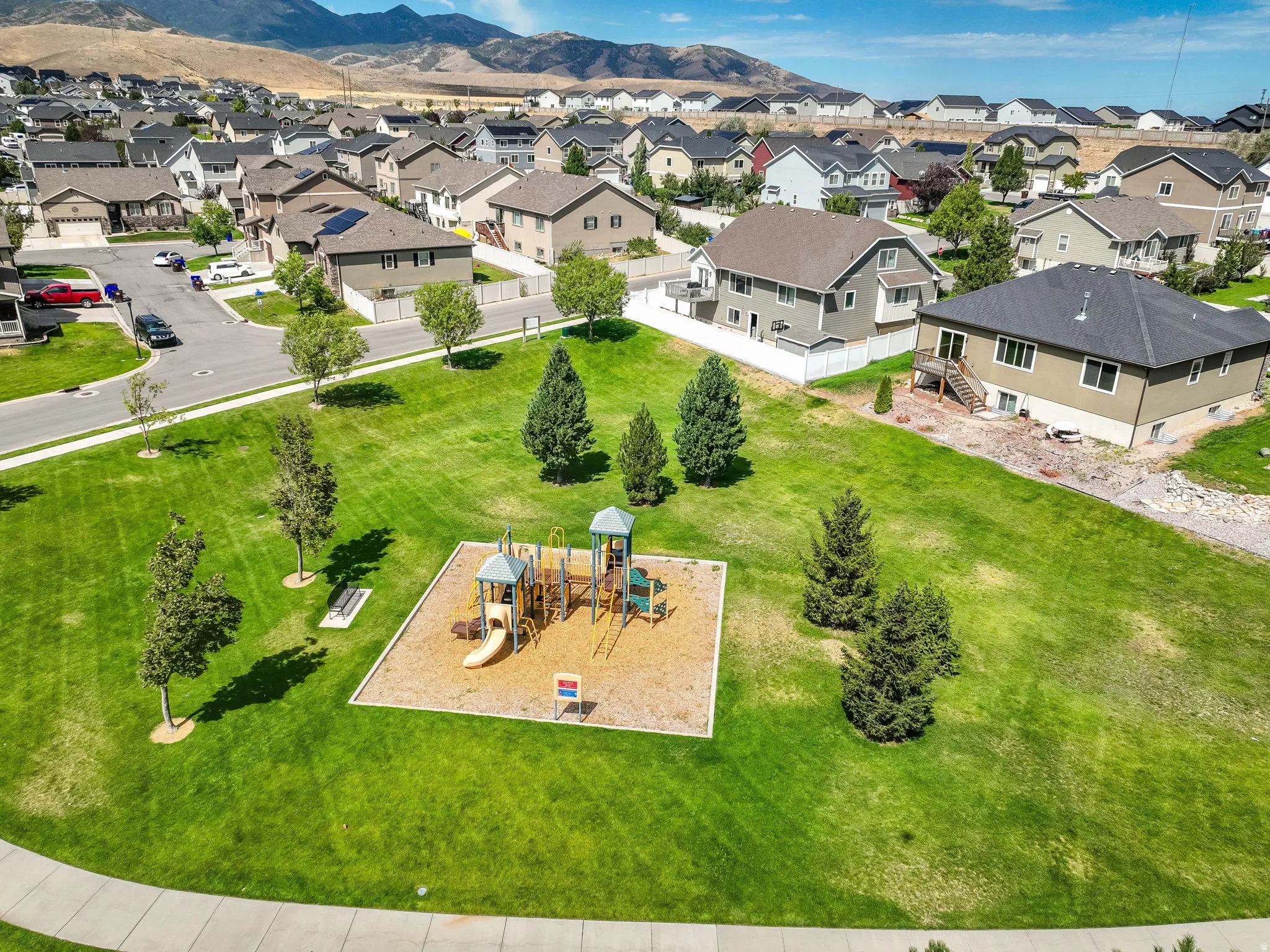 Neighborhood park featuring a playground and expansive green space