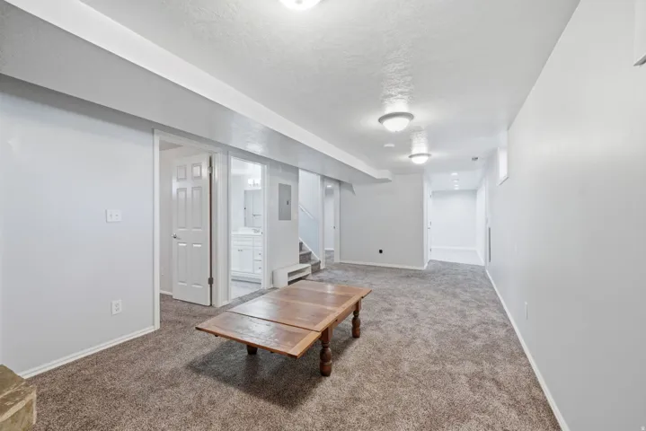 Carpeted flooring, recessed ceiling lighting, and a neutral wall color