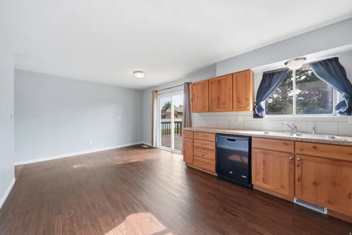 Wood-finish flooring, light-toned walls, and a sliding glass door