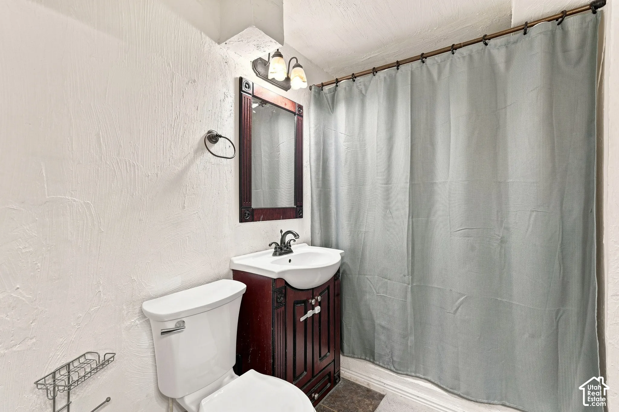 White toilet with a dark wood-finish vanity
