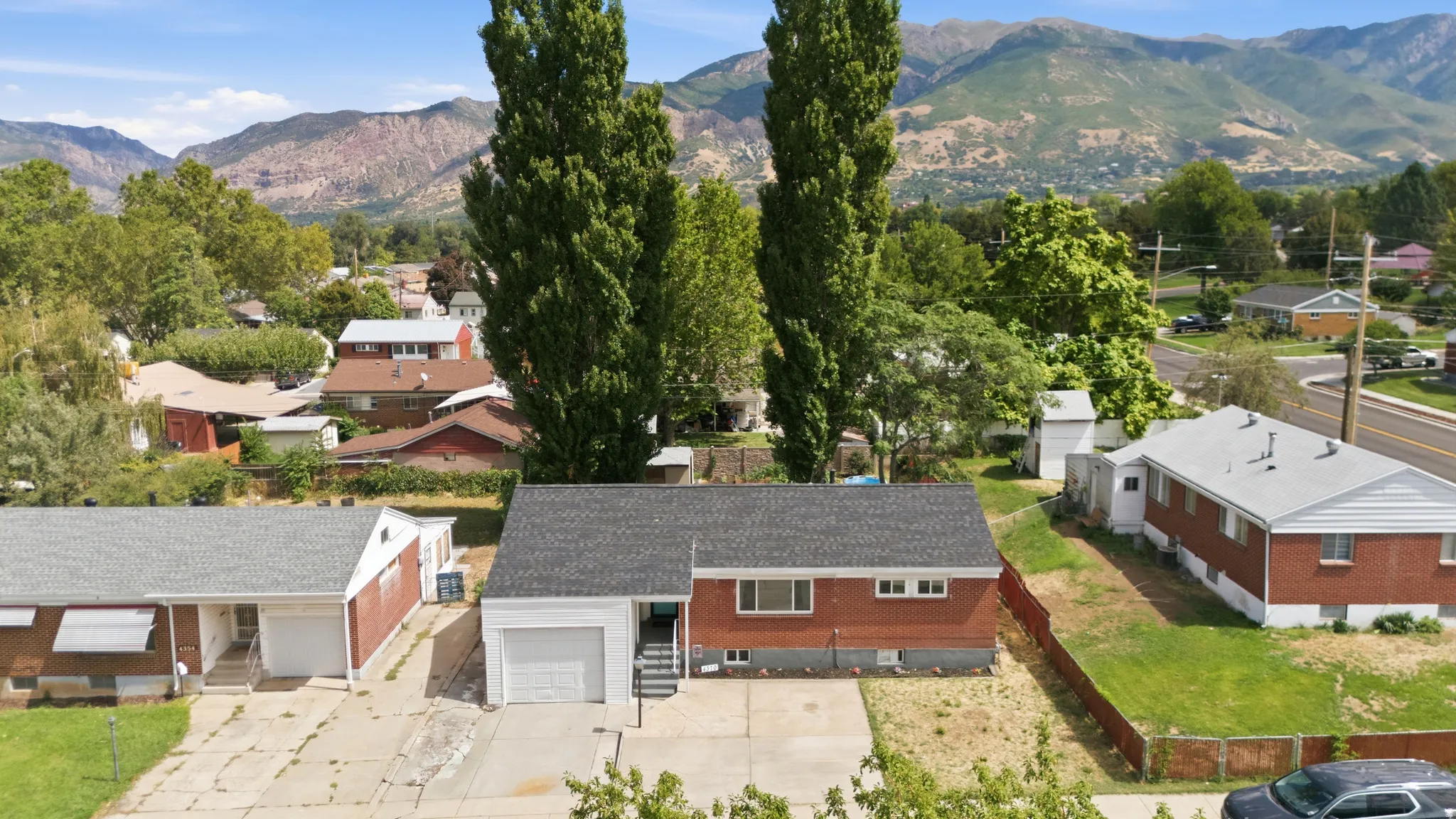 Brick exterior residence with an attached tandem 2-car garage and a paved driveway