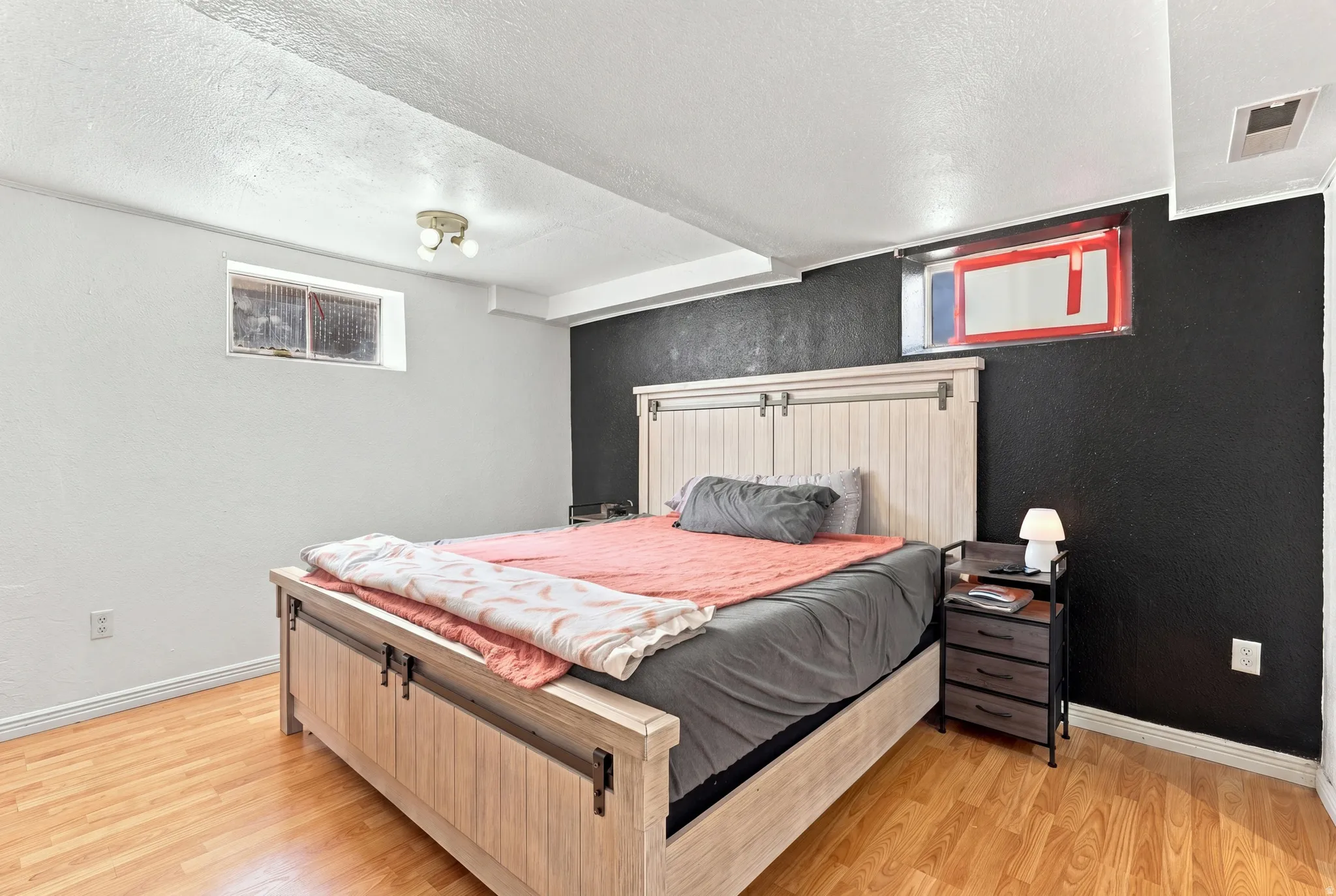 Wood-finish flooring with dual-tone wall finishes and overhead lighting