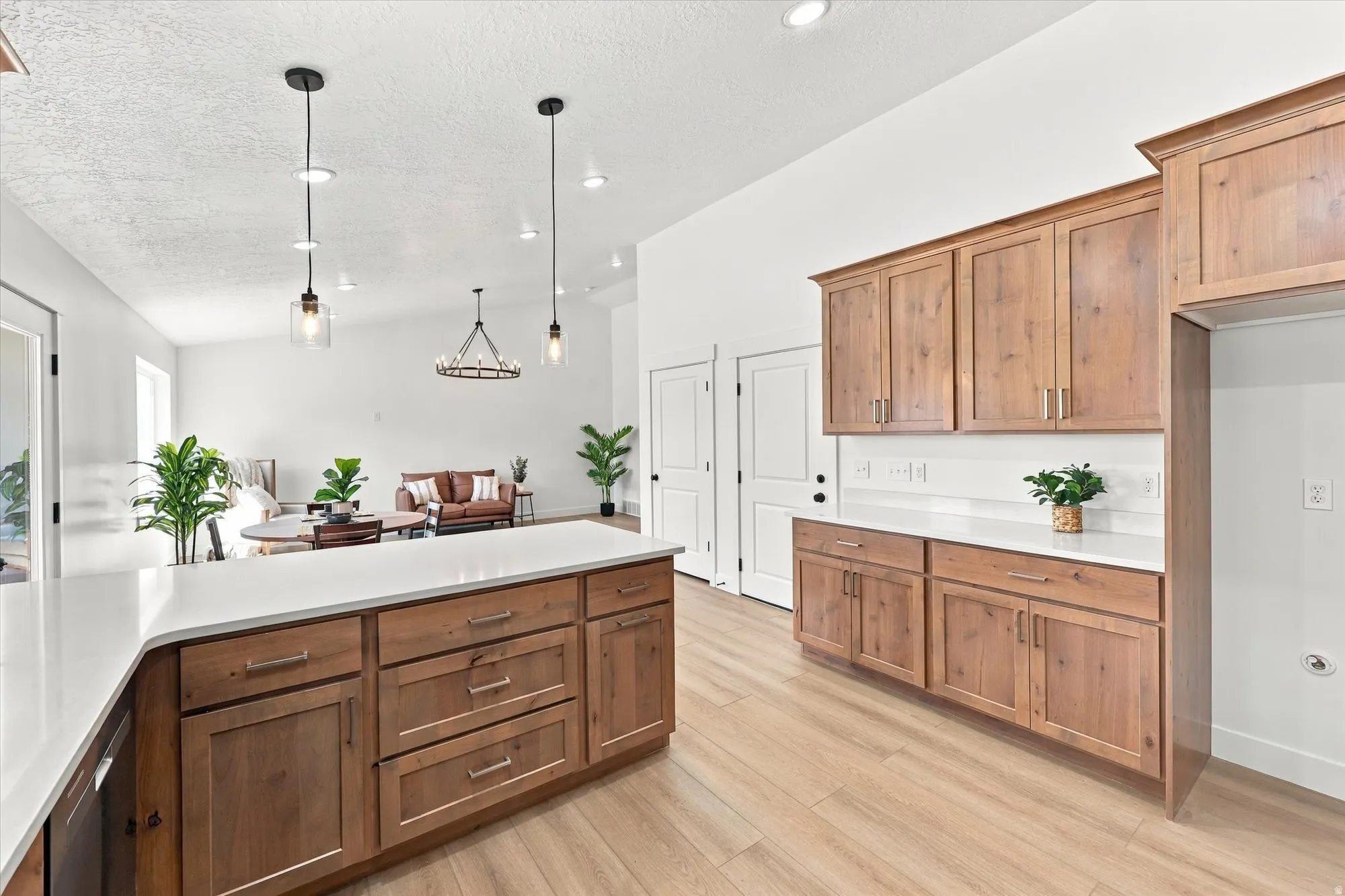 Kitchen featuring wood-finish cabinetry, white countertops, and recessed lighting