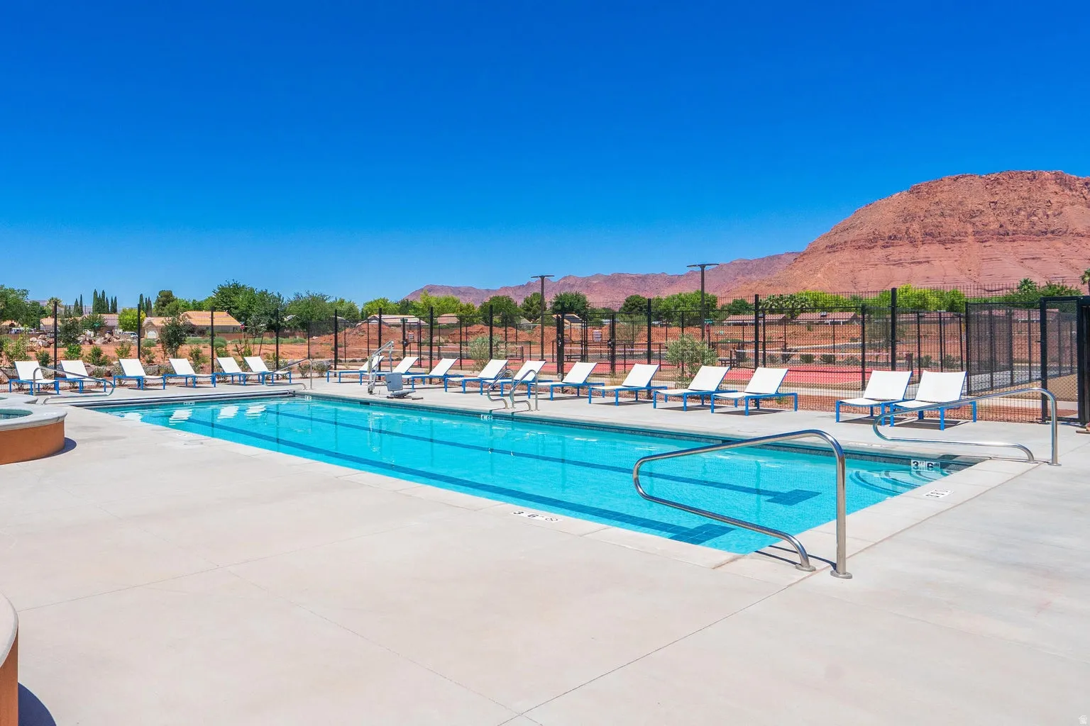 Community swimming pool with surrounding concrete decking