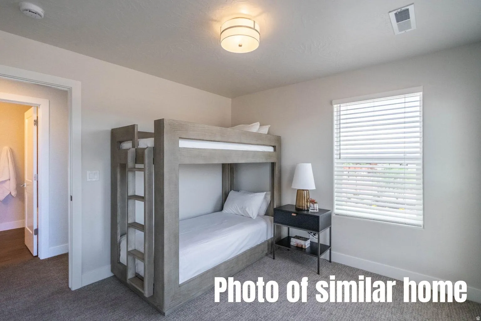 Recessed window with horizontal blinds, overhead flush-mount lighting, and wall-to-wall carpeting