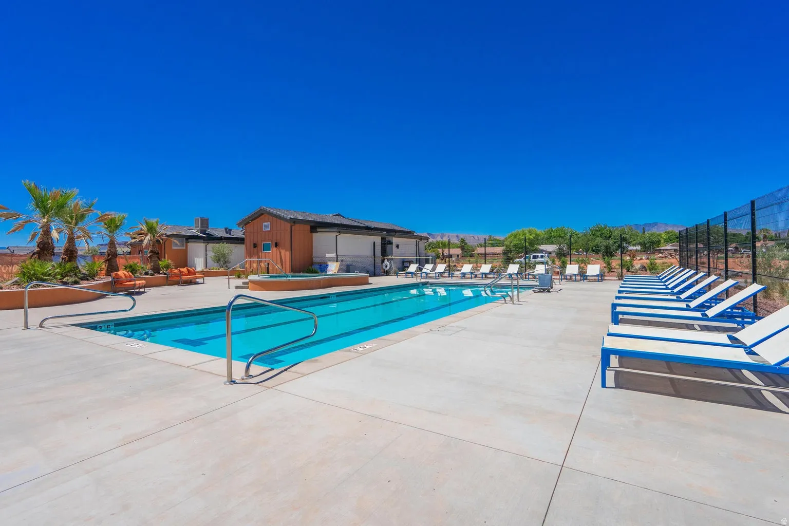 Swimming pool with integrated spa and surrounding concrete decking