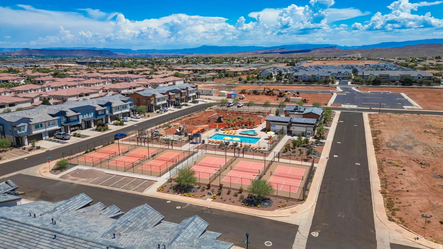 Community featuring multiple pickleball courts, a central swimming pool, and a clubhouse