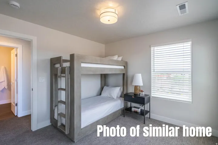 Recessed window with horizontal blinds, overhead flush-mount lighting, and wall-to-wall carpeting