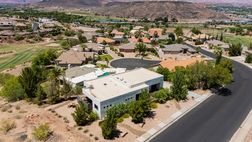 Contemporary residence with a flat roofline, integrated two-car garage, and desert-inspired landscaping