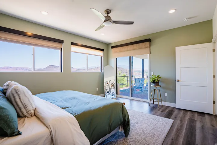 Recessed lighting, a ceiling fan, three-panel interior door, and dark wood-finish flooring