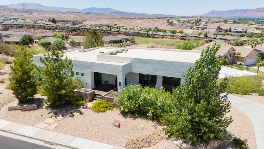 Contemporary architecture with a flat roofline, stucco exterior, and integrated planters