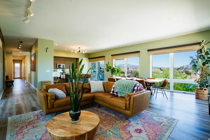 Open-concept living space featuring wood-finish flooring, recessed lighting, and expansive windows