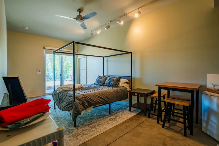 Vaulted ceiling with track lighting and ceiling fan