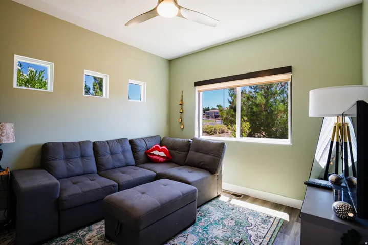 Recessed lighting, wood-finish flooring, ceiling fan, multiple windows