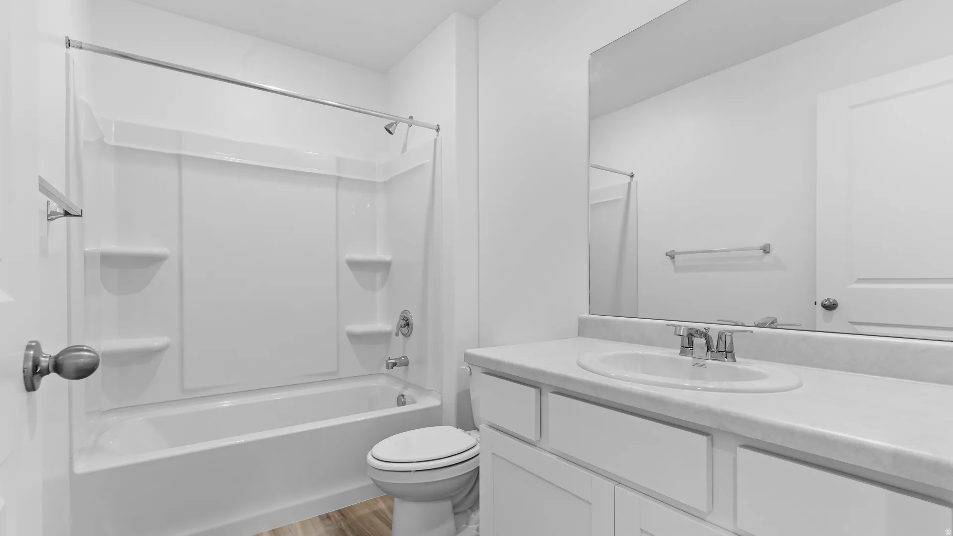 White vanity with an integrated sink, polished chrome faucet, and rectangular mirror