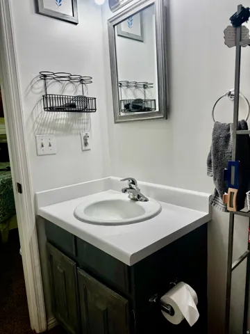 White countertop vanity with an integrated sink and chrome faucet