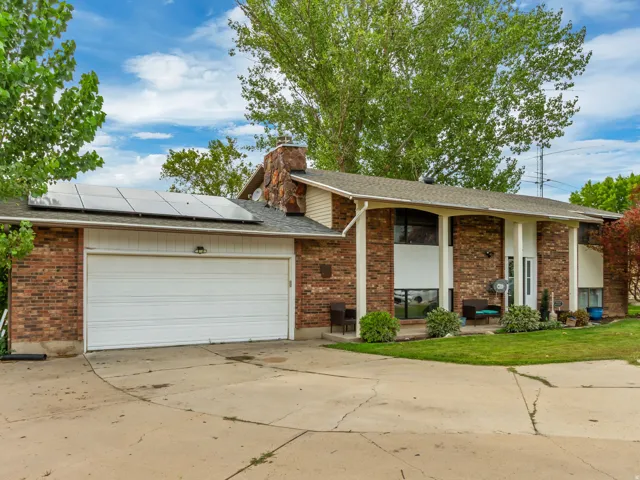 Brick exterior with solar panels and an attached two-car garage