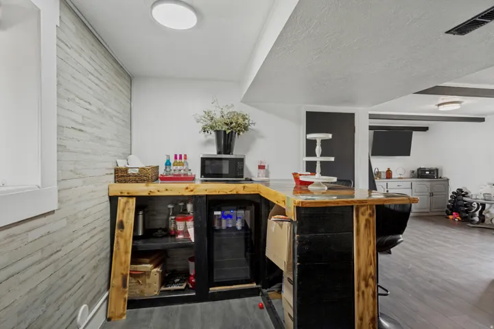 Custom-built bar with wood finishes and an integrated beverage refrigerator
