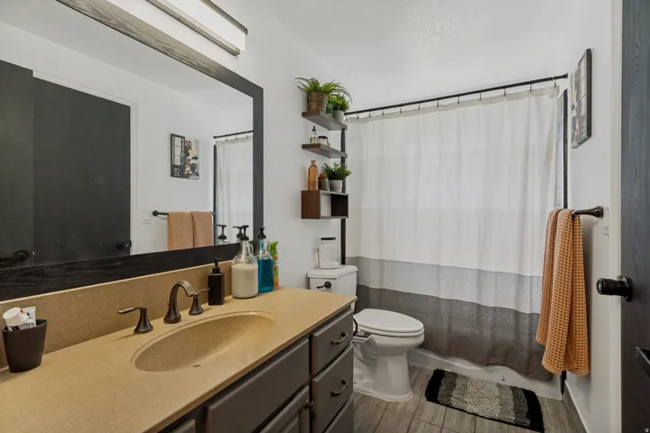 Bathroom vanity with an integrated sink and bronze-finish hardware
