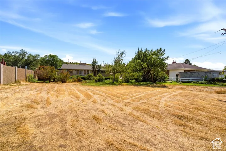 Expansive lot featuring dry landscaping and perimeter fencing