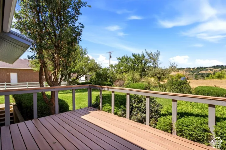 Expansive outdoor deck with wood-finish decking and a wooden railing