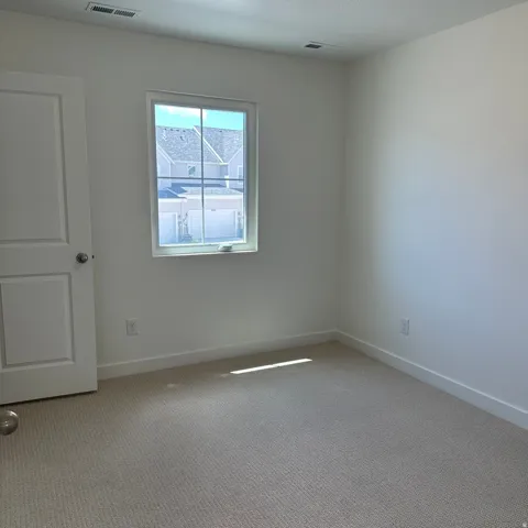 Neutral carpet flooring and white painted walls
