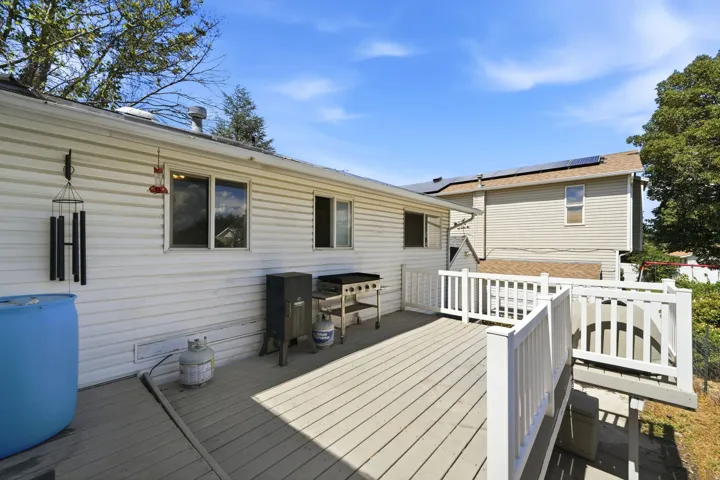 Outdoor deck with composite decking and white railings