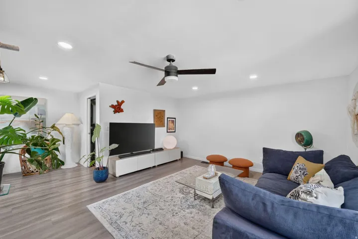 Wood-finish flooring, recessed lighting, and a ceiling fan