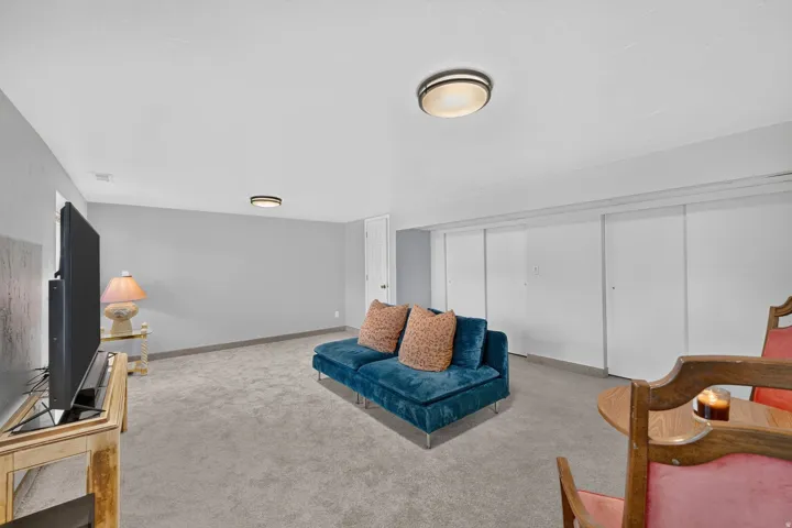 Recessed lighting fixtures, light gray wall paint, and gray carpeting
