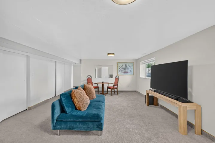 Recessed lighting, light gray carpet, window with natural light, built-in closet storage, and neutral wall tones
