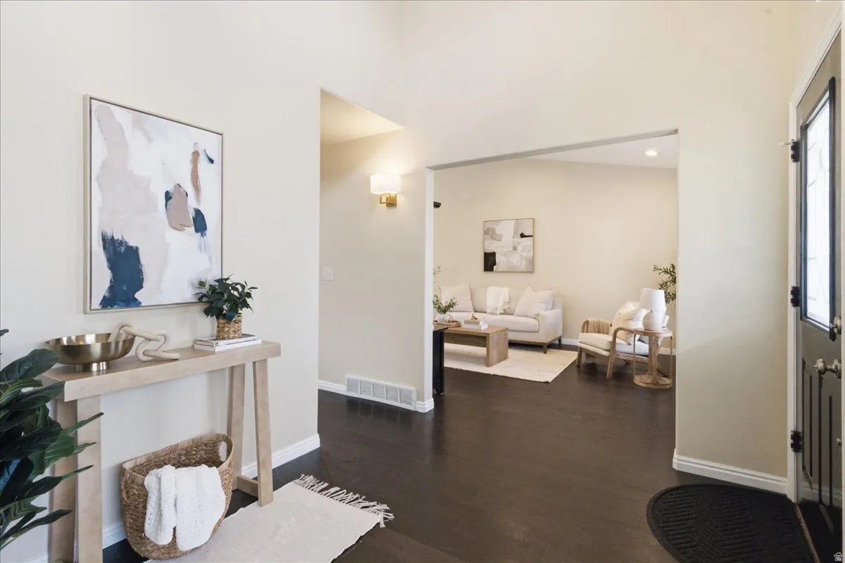 Dark wood-finish flooring, light-toned walls, and a white trim
