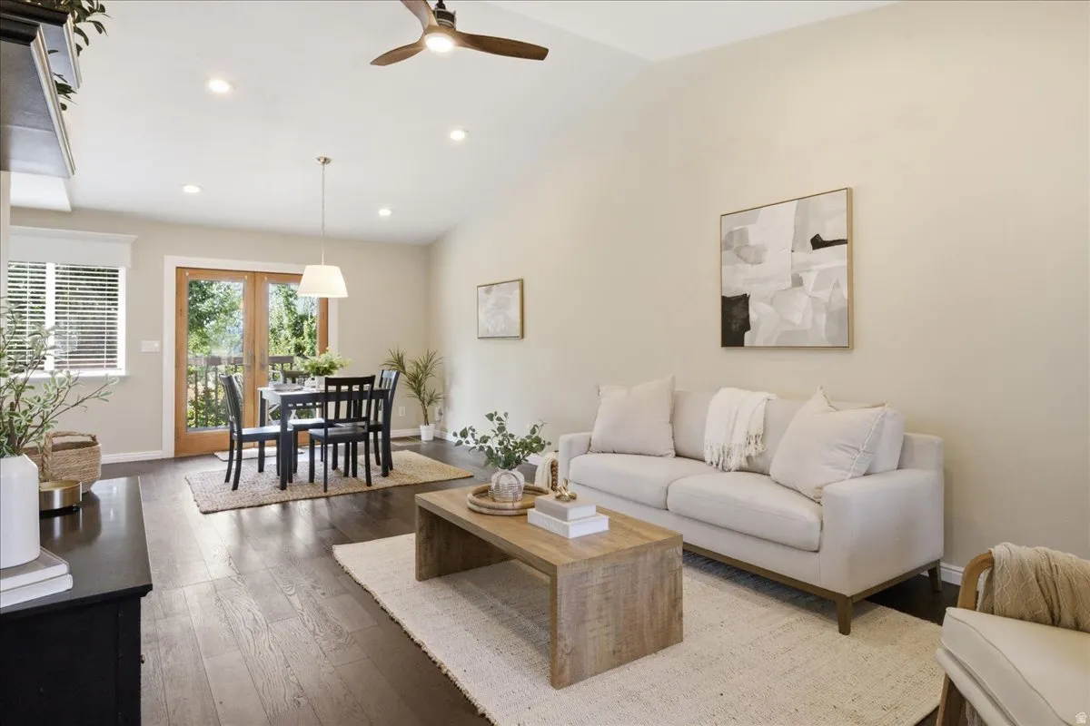Vaulted ceiling, wood-finish flooring, recessed lighting, and French doors