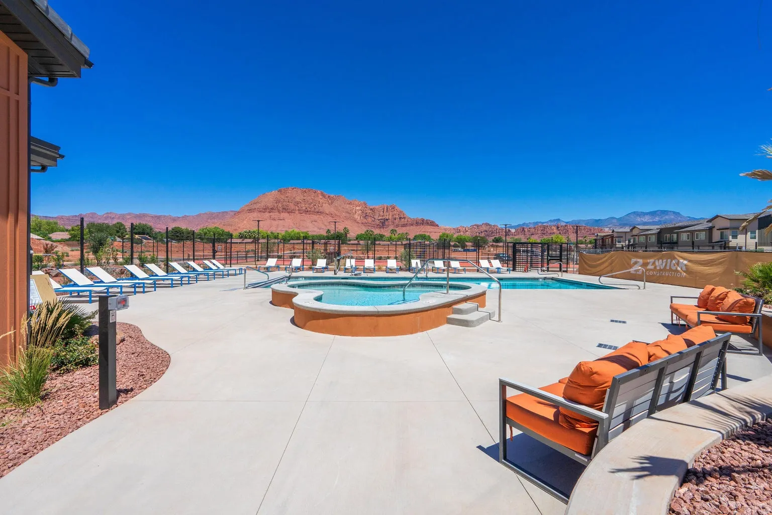 Outdoor amenity area featuring a swimming pool, integrated spa, and concrete deck