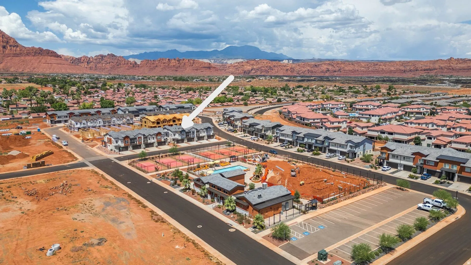 Townhome community with extensive hardscaping, multiple tennis courts, and a community pool