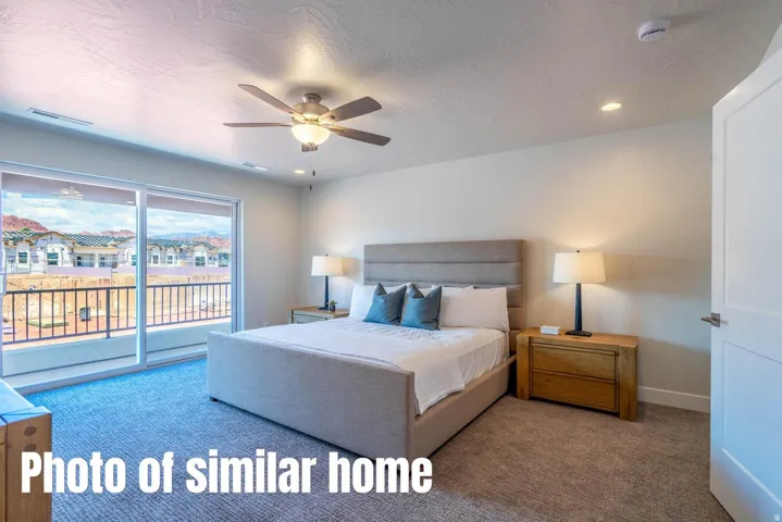 Sliding glass door, recessed lighting, ceiling fan with integrated light, and wall-to-wall carpeting
