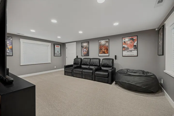 Spacious room featuring neutral carpeting and recessed lighting